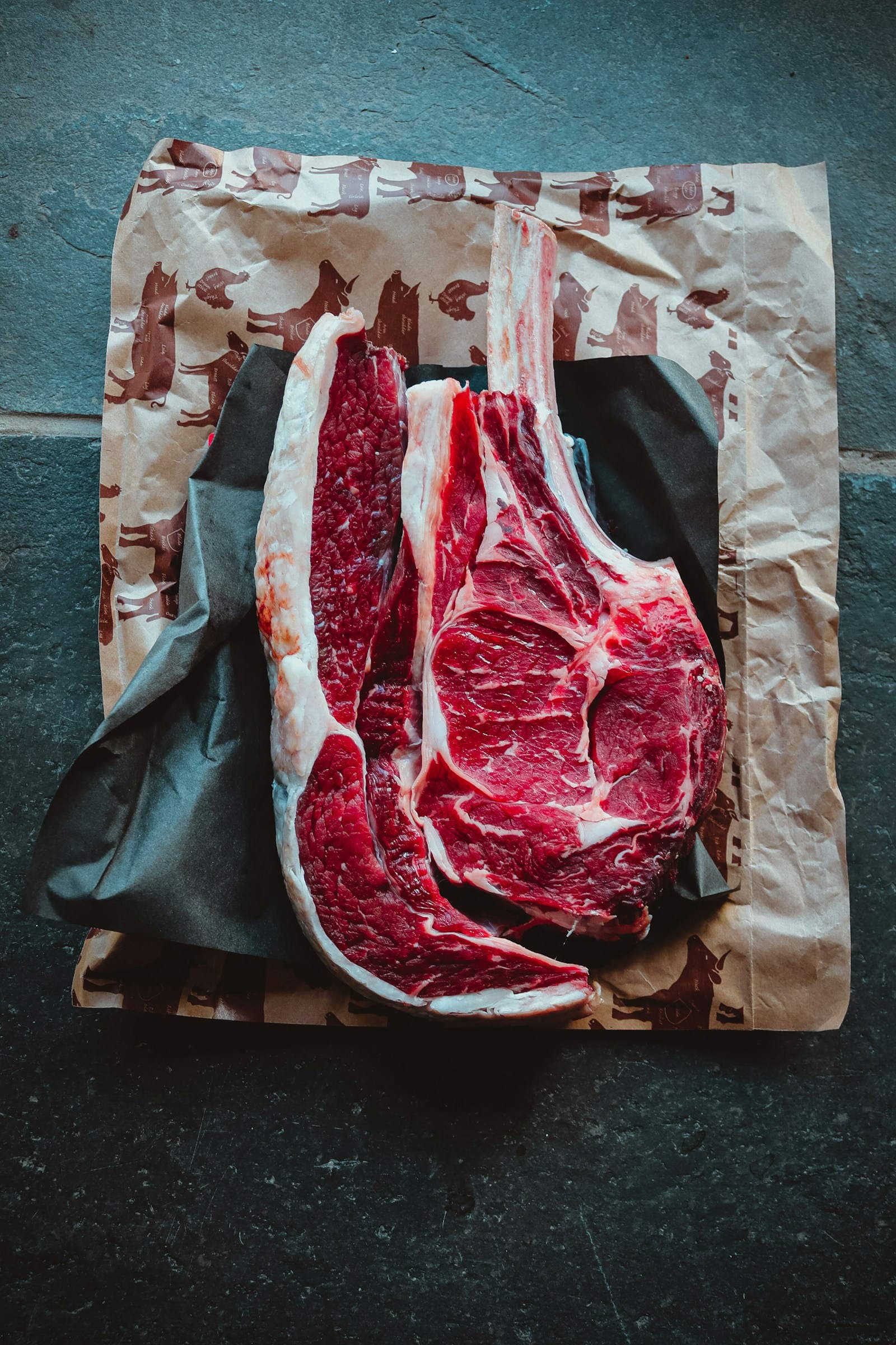 Raw beef steaks laid out on butcher paper